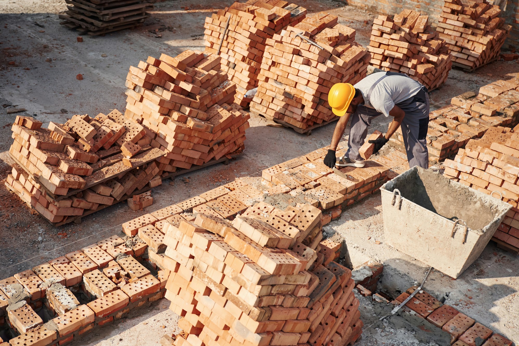 Top view. Handsome Indian man is on the construction site
